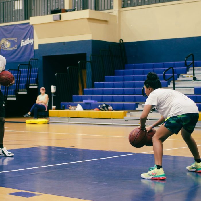 Youth Sports Injuries in Orlando, Florida - Ankle and Knee Post Surgery Relief Youth basketball player in training session with coach, representing sports injury recovery treatments at MOOV Labs Orlando including cryotherapy, red light therapy, and joint rehab solutions.