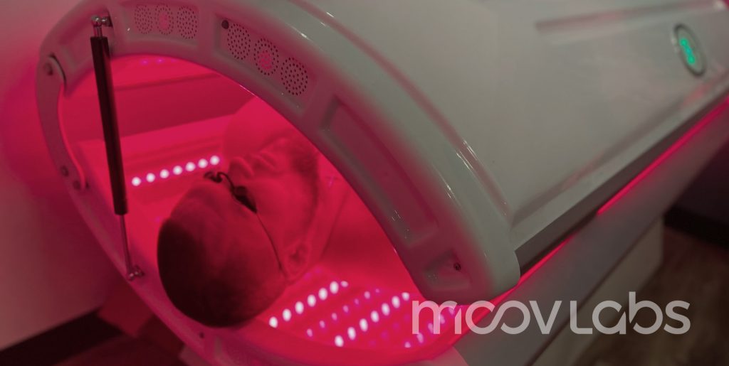 Red Light Bed Therapy in Orlando, FL at Moov Labs Man relaxing under red light therapy bed at Moov Labs in Orlando, Florida, promoting inflammation reduction and full-body recovery.