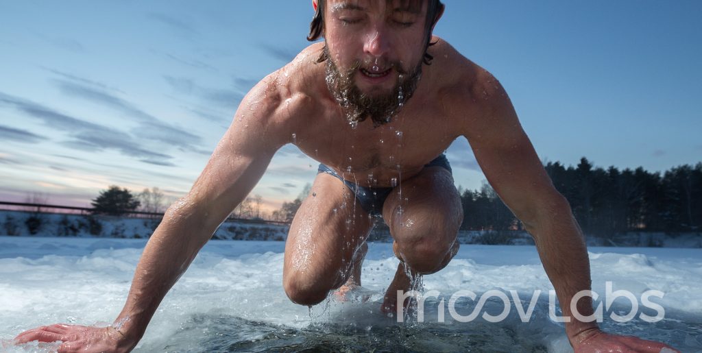 Ice Baths versus Cryotherapy in Orlando - The Difference is More dramatic than you think Man emerging from freezing cold lake, symbolizing natural cold exposure and the benefits of contrast therapy offered at Moov Labs Orlando.