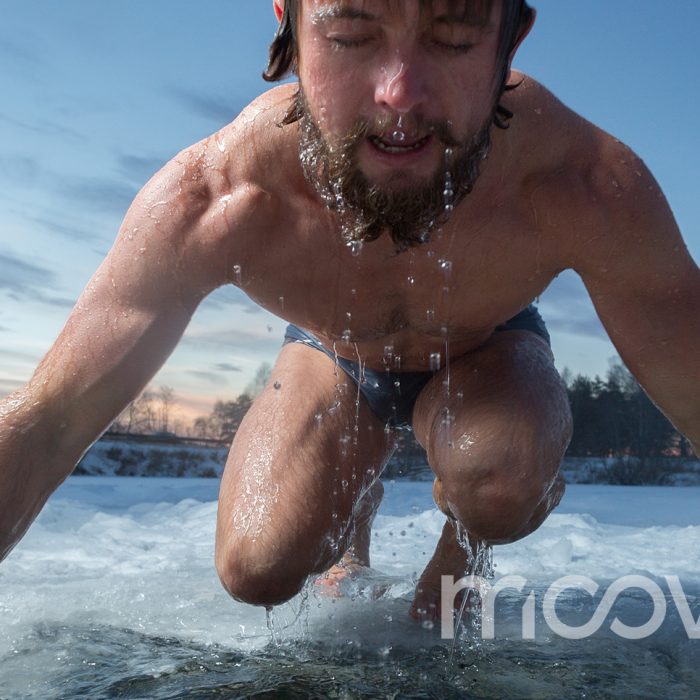 Ice Baths versus Cryotherapy in Orlando - The Difference is More dramatic than you think Man emerging from freezing cold lake, symbolizing natural cold exposure and the benefits of contrast therapy offered at Moov Labs Orlando.