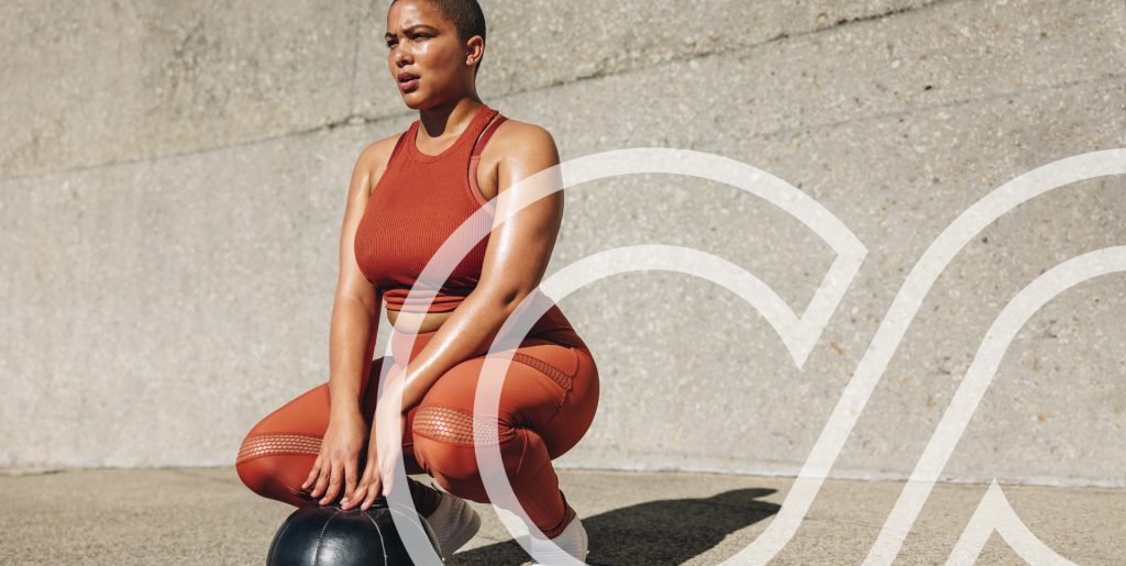 Weight Loss in Orlando with Semaglutide, Tirzepatide, GLP-1 in a safe location A fit woman in athletic wear performing a squat with a medicine ball against a concrete wall, representing strength, fitness, and weight loss in Orlando. Associated with Semaglutide, Tirzepatide, and GLP-1 treatments.